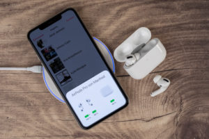 Apple iPhone 11 Pro Max lies on charging pad, display shows charging status of AirPods Pro, wireless charging, Apple iPhone 11 Pro Max lies on charging pad, display shows charging status of AirPods Pro, wireless charging,